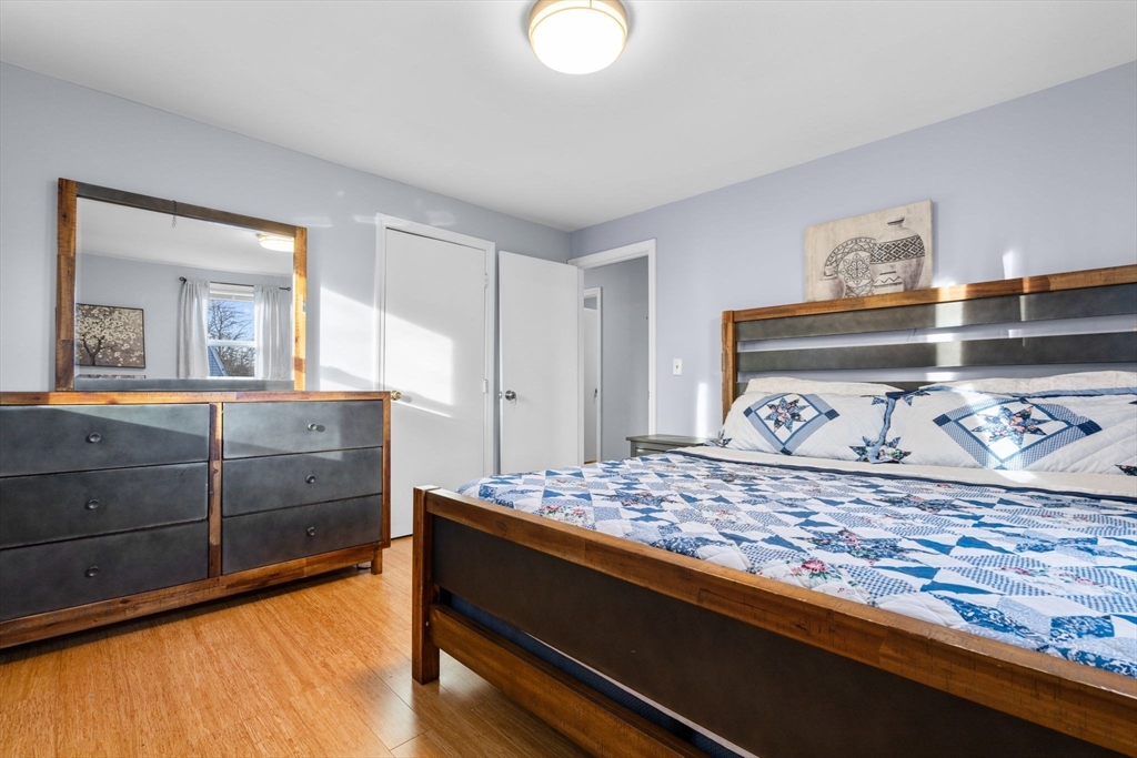 62 Emily Jeffers Road, Unit 62 Randolph, MA 02368 - Photo 24 of 31 a bedroom with a bed and a dresser