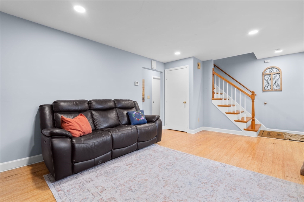 62 Emily Jeffers Road, Unit 62 Randolph, MA 02368 - Photo 25 of 31 a living room with furniture and a ceiling fan