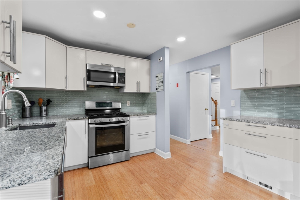 62 Emily Jeffers Road, Unit 62 Randolph, MA 02368 - Photo 6 of 31 a kitchen with stainless steel appliances granite countertop a stove a sink and a refrigerator