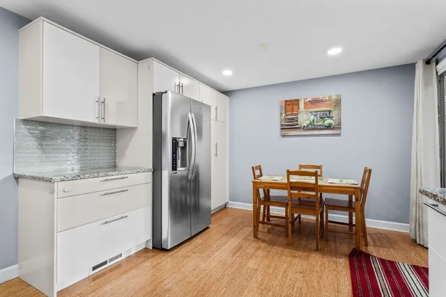 a kitchen with stainless steel appliances granite countertop a refrigerator and a stove top oven