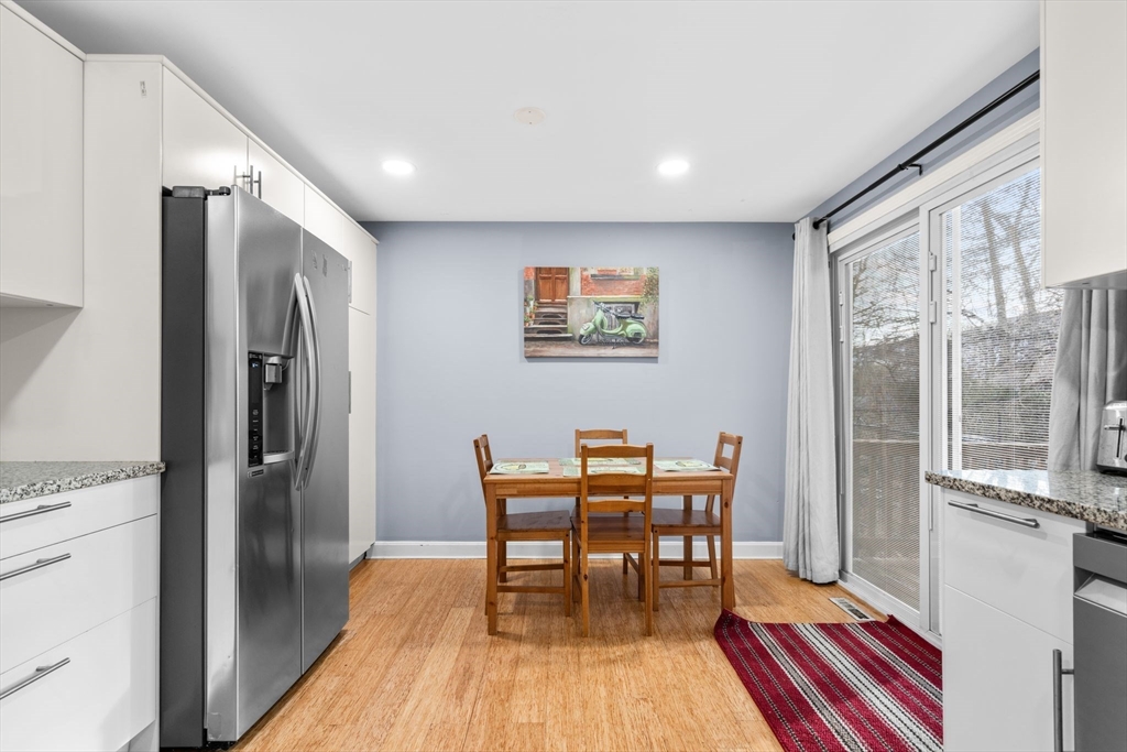 62 Emily Jeffers Road, Unit 62 Randolph, MA 02368 - Photo 9 of 31 a view of a kitchen with dining table and stainless steel appliances