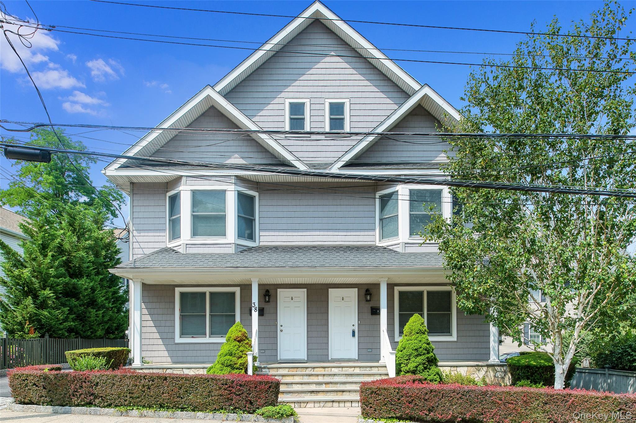 38 High Street, Unit LEFT Rye, NY 10580 - Photo 1 of 1 a front view of a house with garden