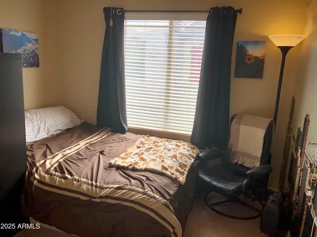 a bedroom with a bed and a window