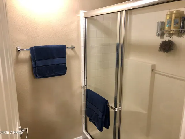 a bathroom with a glass shower door