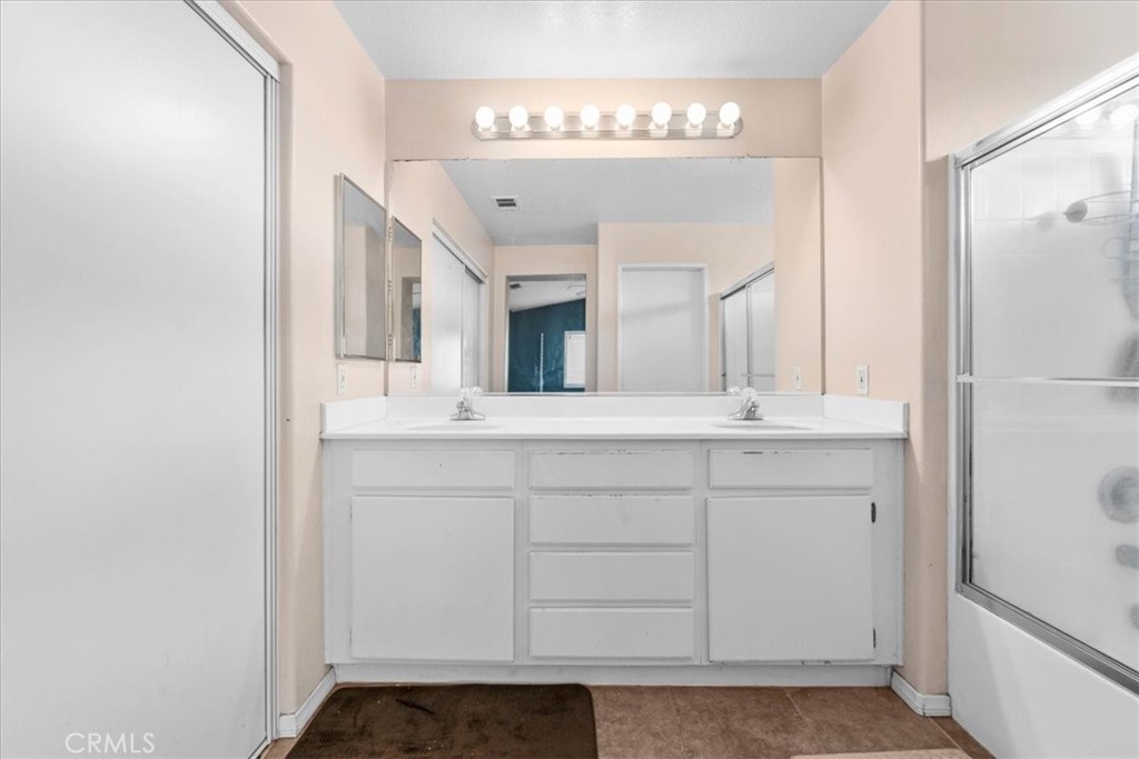 1474 Albillo Loop Perris, CA 92571 - Photo 19 of 35 a bathroom with a sink and a mirror