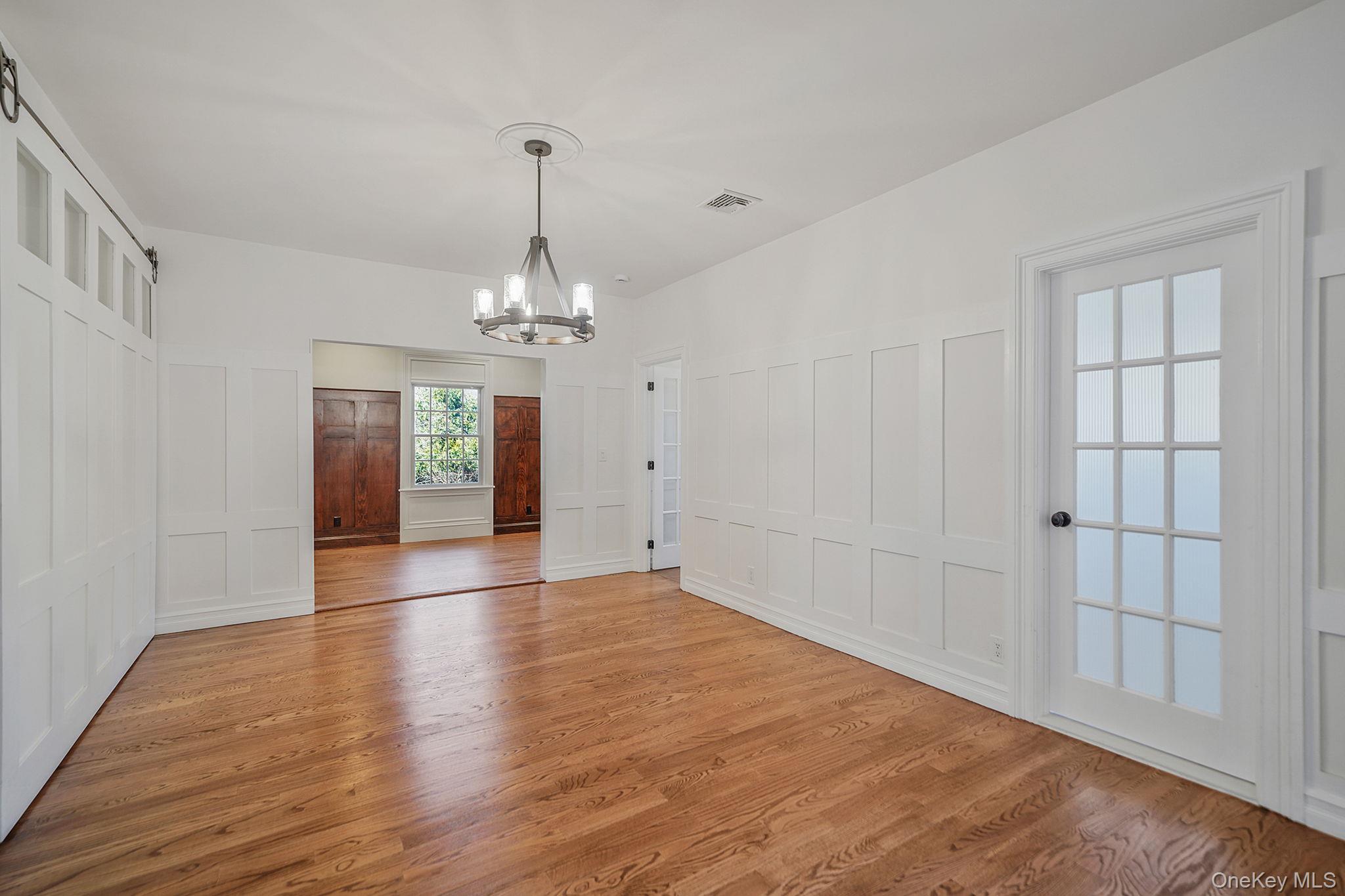 368 Main Street Setauket, NY 11733 - Photo 11 of 41 wooden floor in an empty room with a window