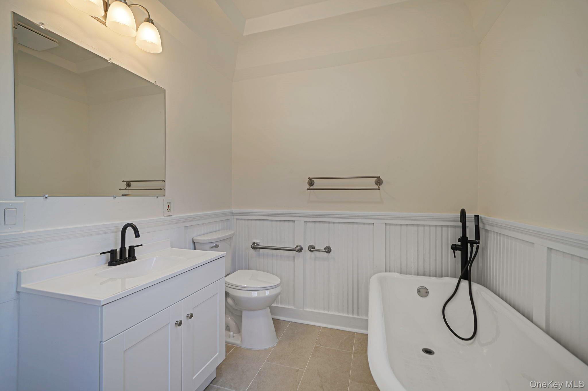 368 Main Street Setauket, NY 11733 - Photo 14 of 41 a bathroom with a toilet sink and mirror