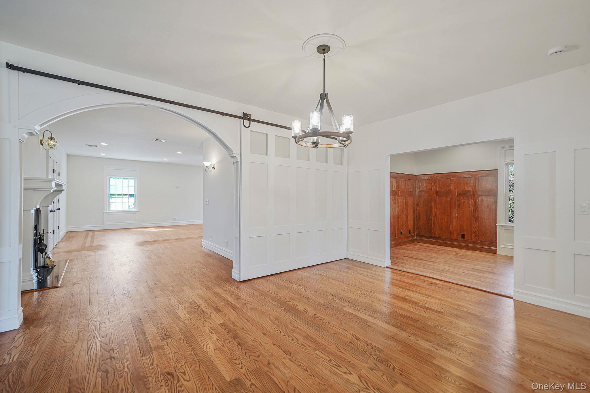 368 Main Street Setauket, NY 11733 - Photo 15 of 41 a view of a livingroom with wooden floor staircase and a kitchen space