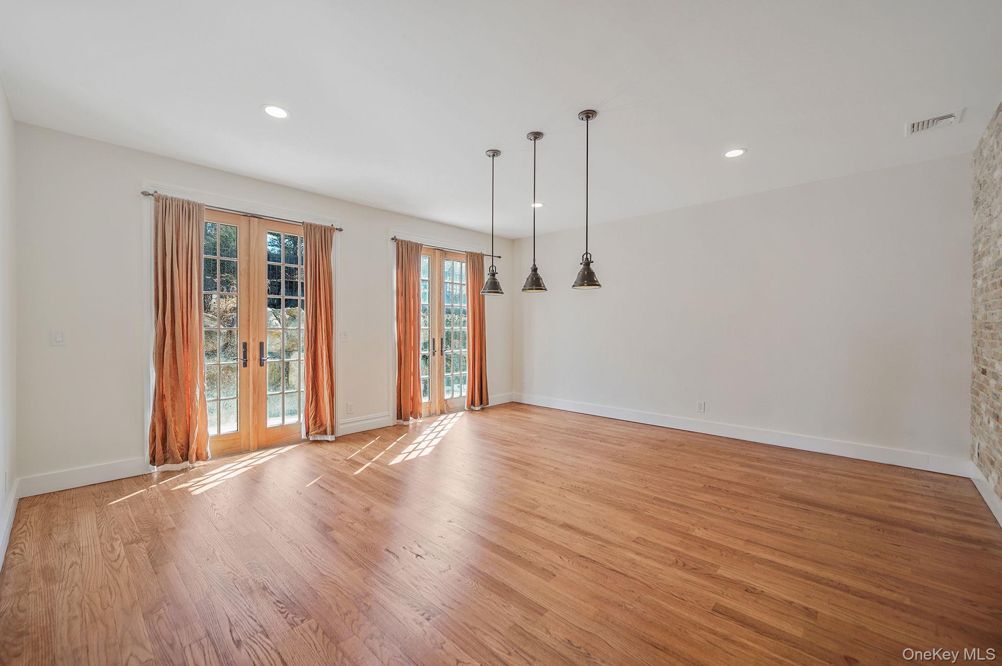 368 Main Street Setauket, NY 11733 - Photo 16 of 41 a view of an empty room with wooden floor and a window