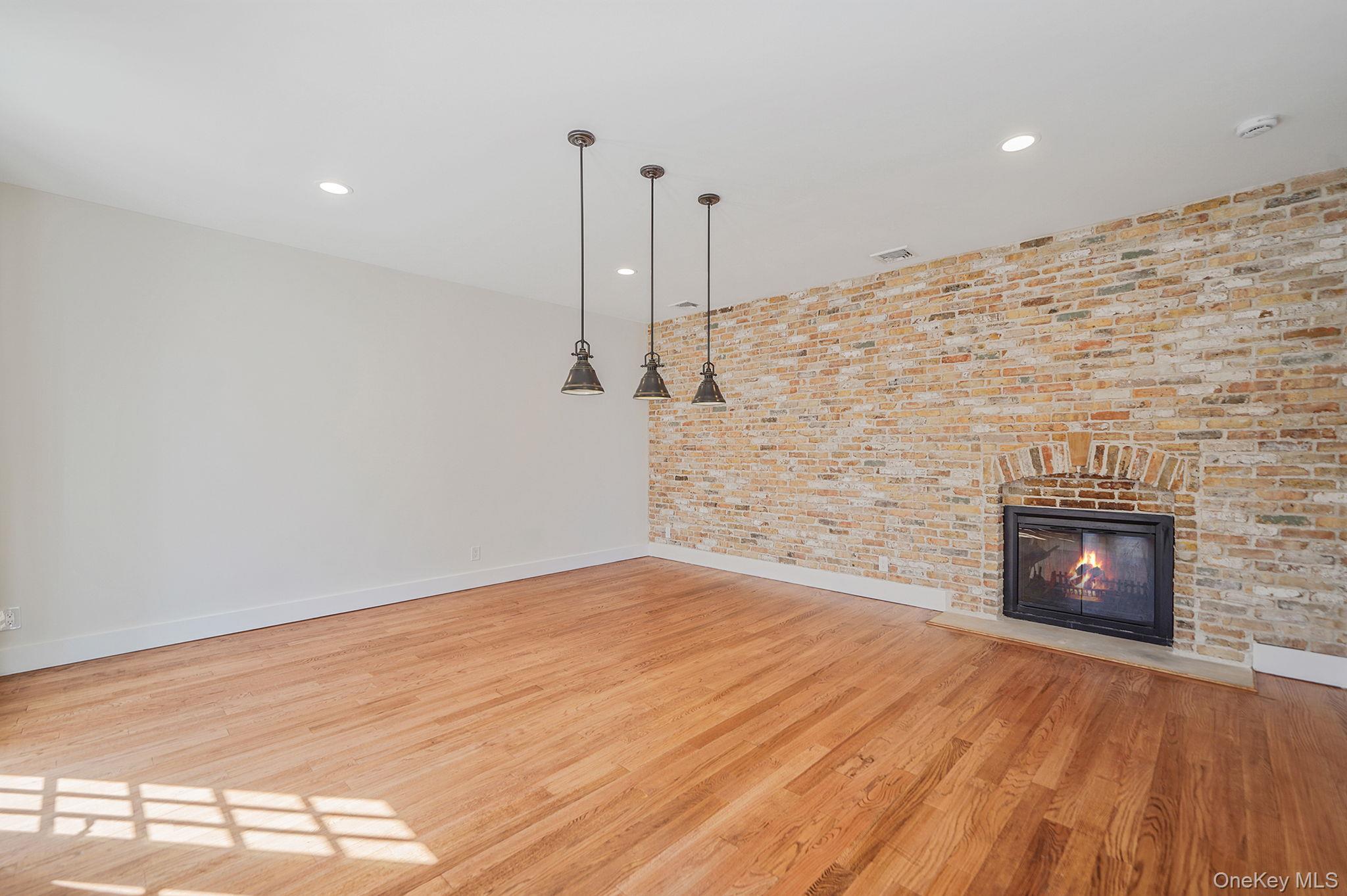 368 Main Street Setauket, NY 11733 - Photo 17 of 41 a view of empty room with wooden floor and fireplace