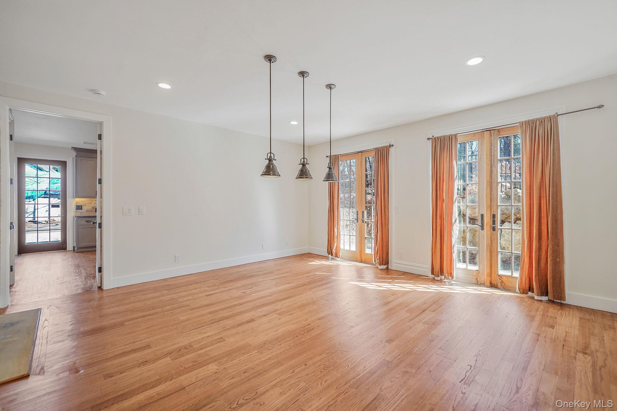 368 Main Street Setauket, NY 11733 - Photo 18 of 41 a view of an empty room with wooden floor and a window