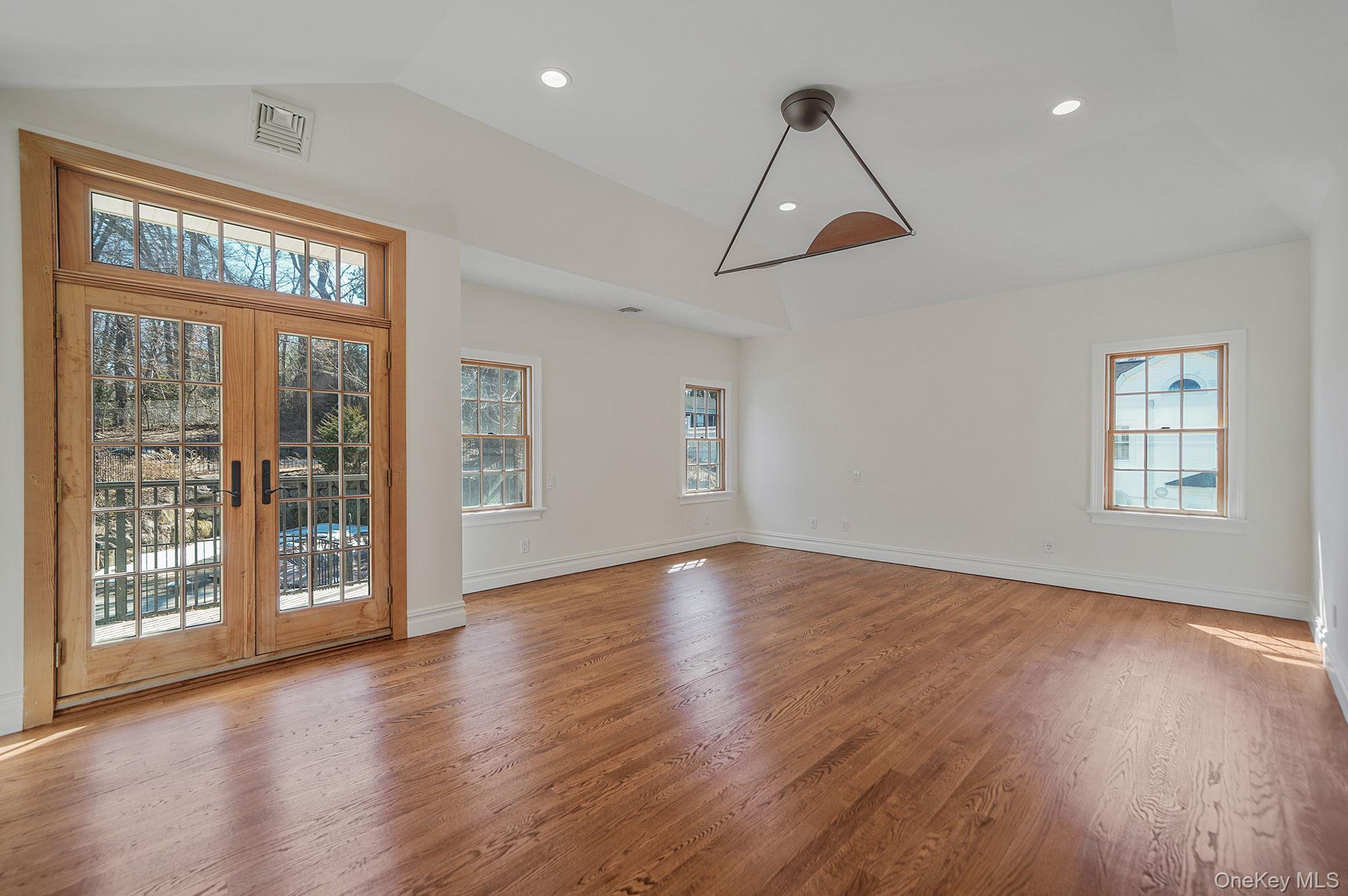 368 Main Street Setauket, NY 11733 - Photo 19 of 41 a view of an empty room with wooden floor and a window
