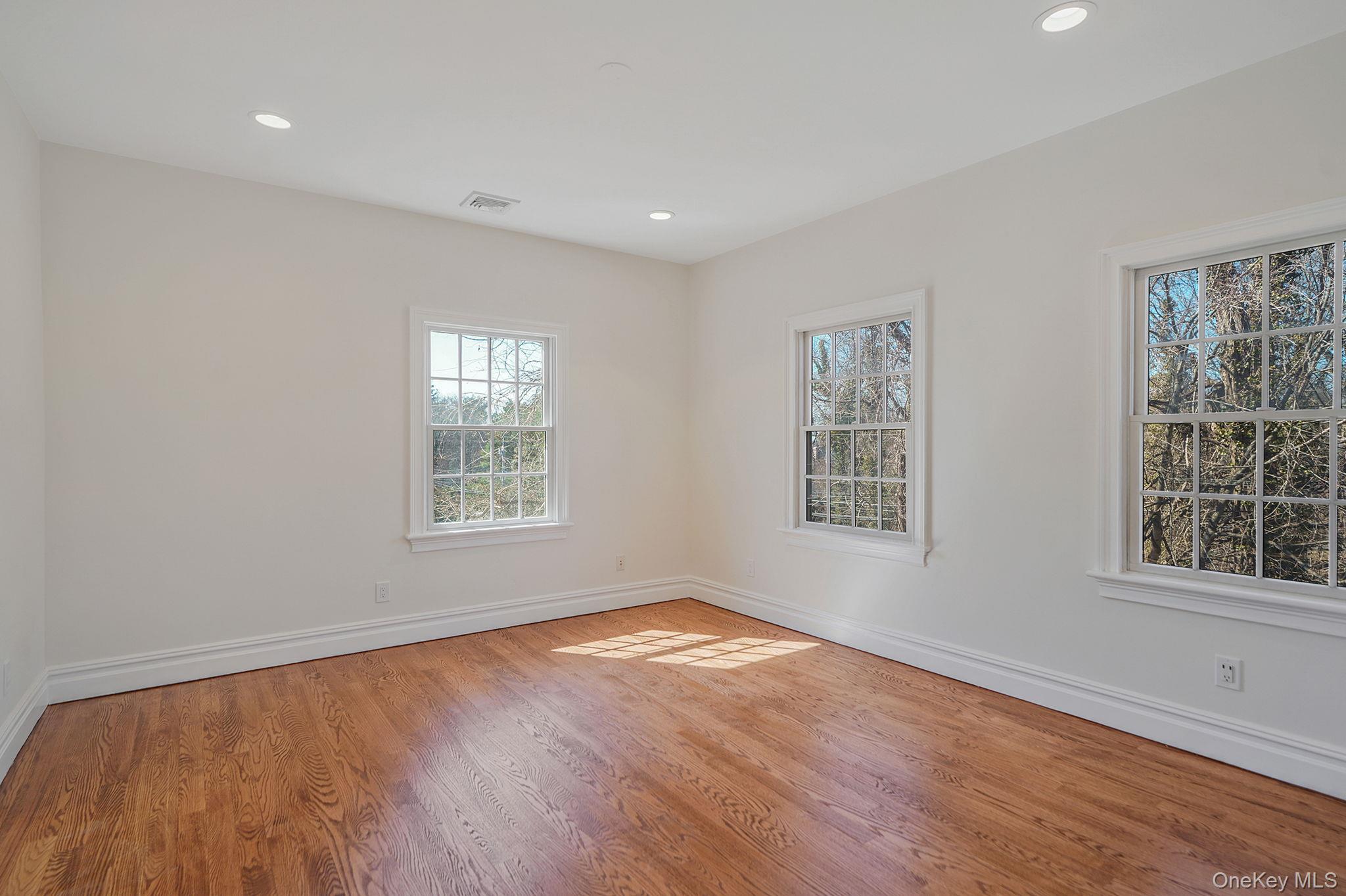 368 Main Street Setauket, NY 11733 - Photo 25 of 41 a view of an empty room with wooden floor and a window