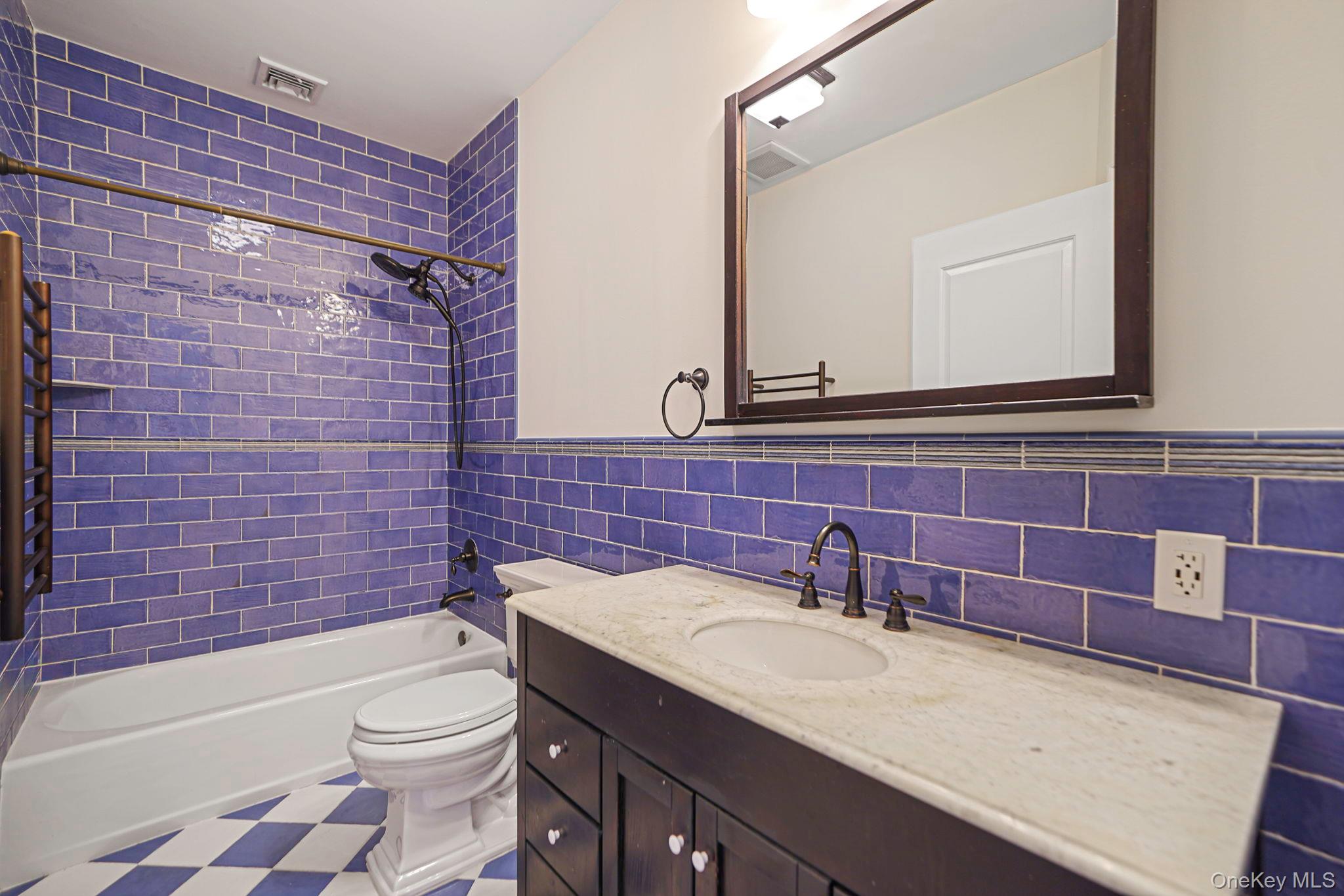 368 Main Street Setauket, NY 11733 - Photo 31 of 41 a bathroom with a granite countertop toilet sink and mirror