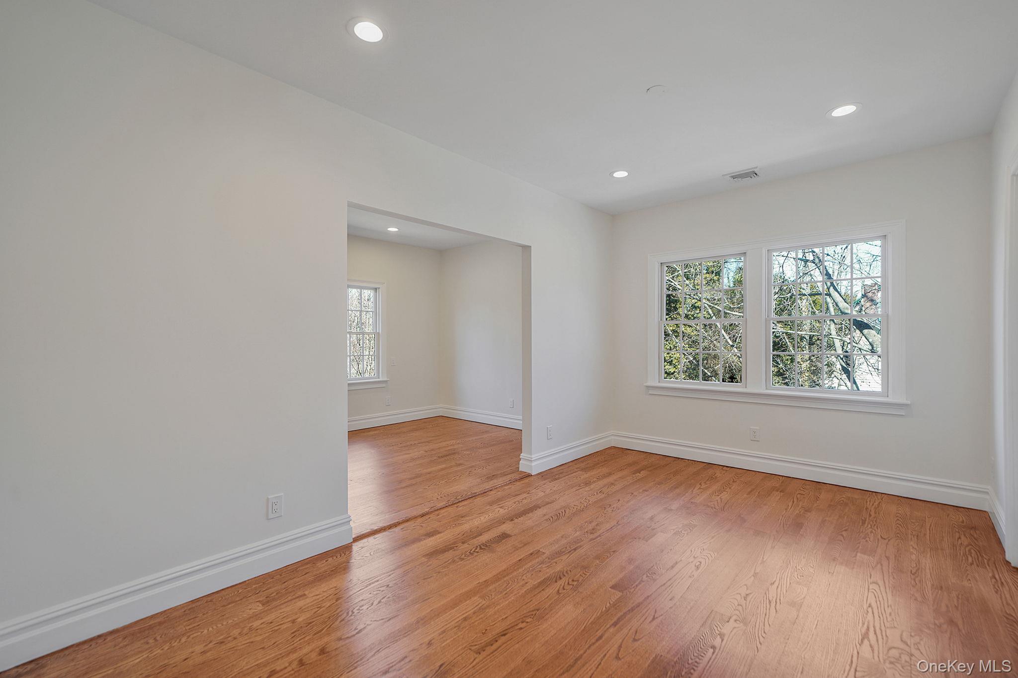 368 Main Street Setauket, NY 11733 - Photo 32 of 41 an empty room with wooden floor and windows