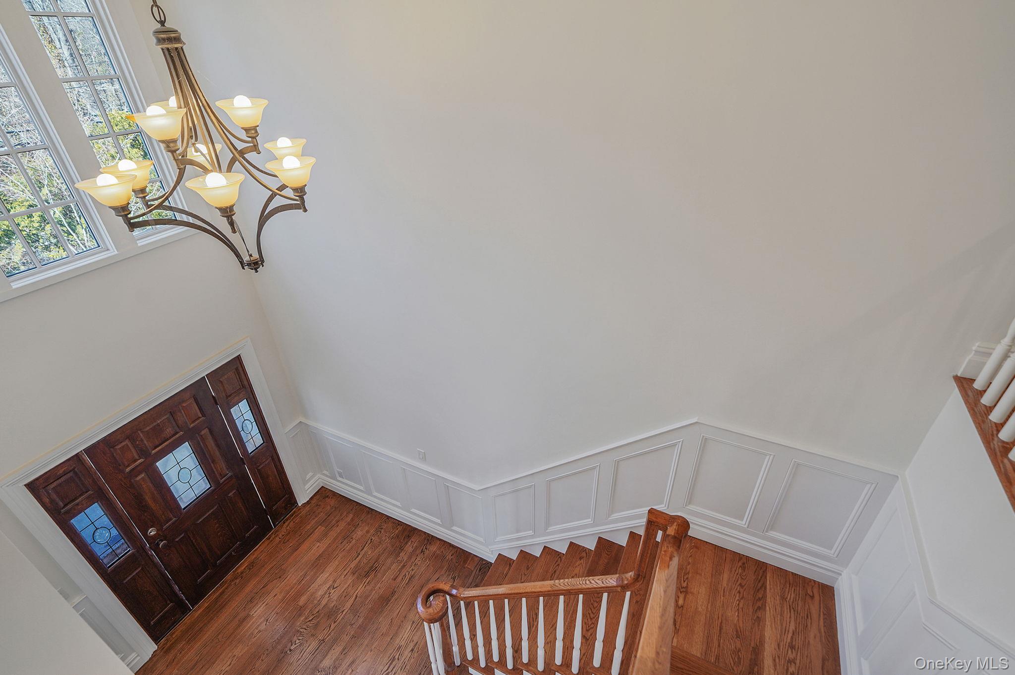 368 Main Street Setauket, NY 11733 - Photo 35 of 41 a view of a hallway with wooden floor and stairs