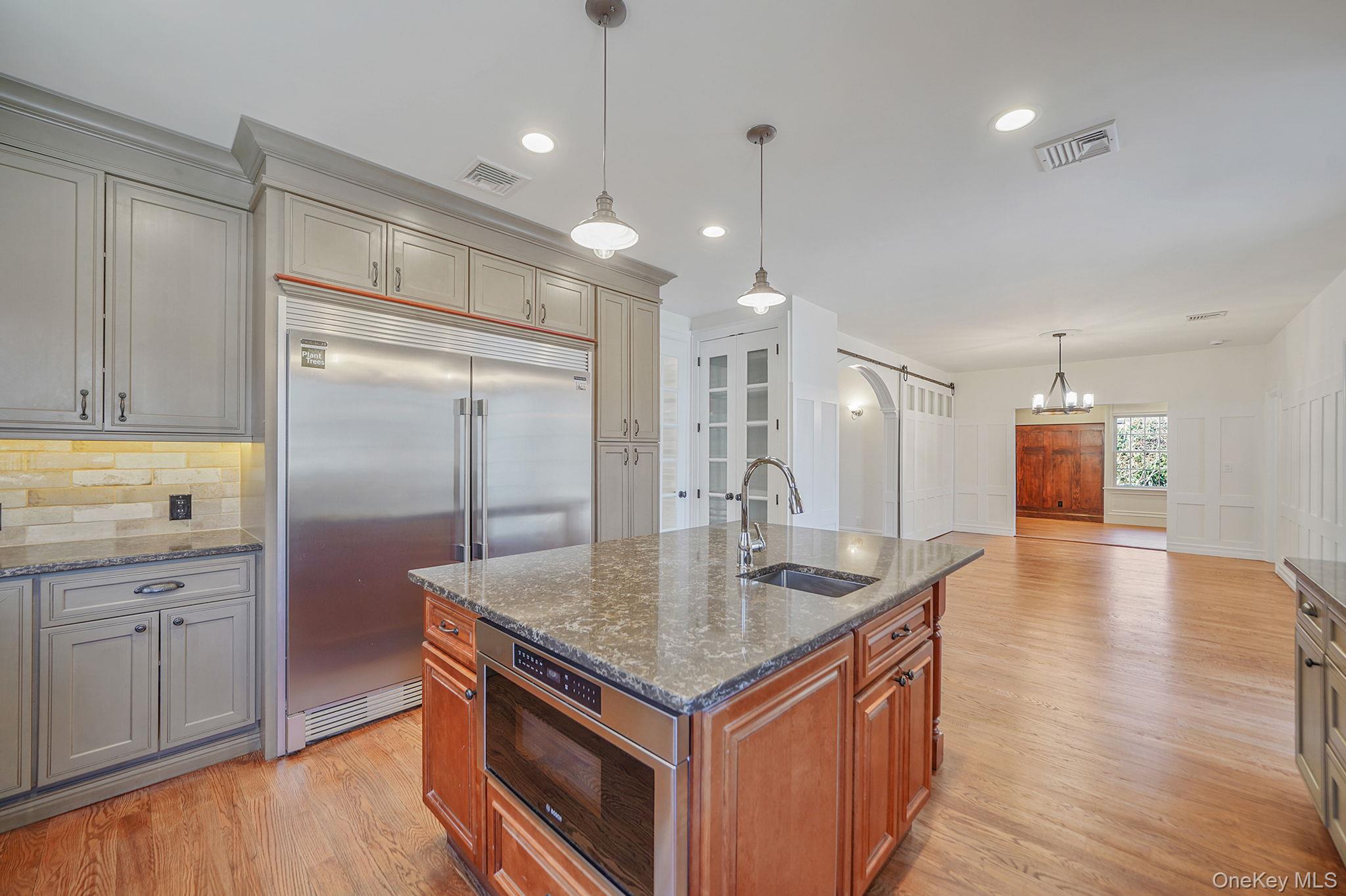 368 Main Street Setauket, NY 11733 - Photo 4 of 41 a kitchen with stainless steel appliances granite countertop a refrigerator a sink and a stove top oven