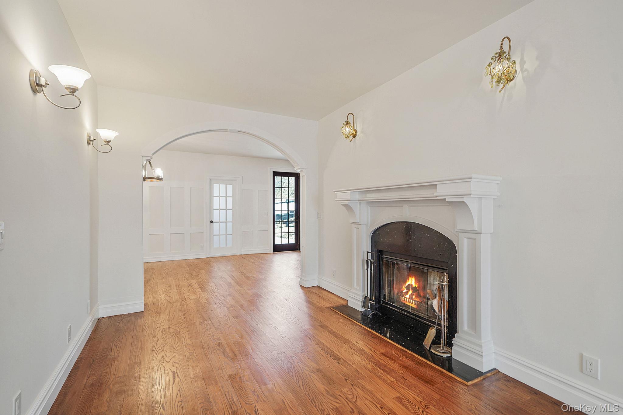 368 Main Street Setauket, NY 11733 - Photo 8 of 41 a view of a livingroom with wooden floor a fireplace and a window