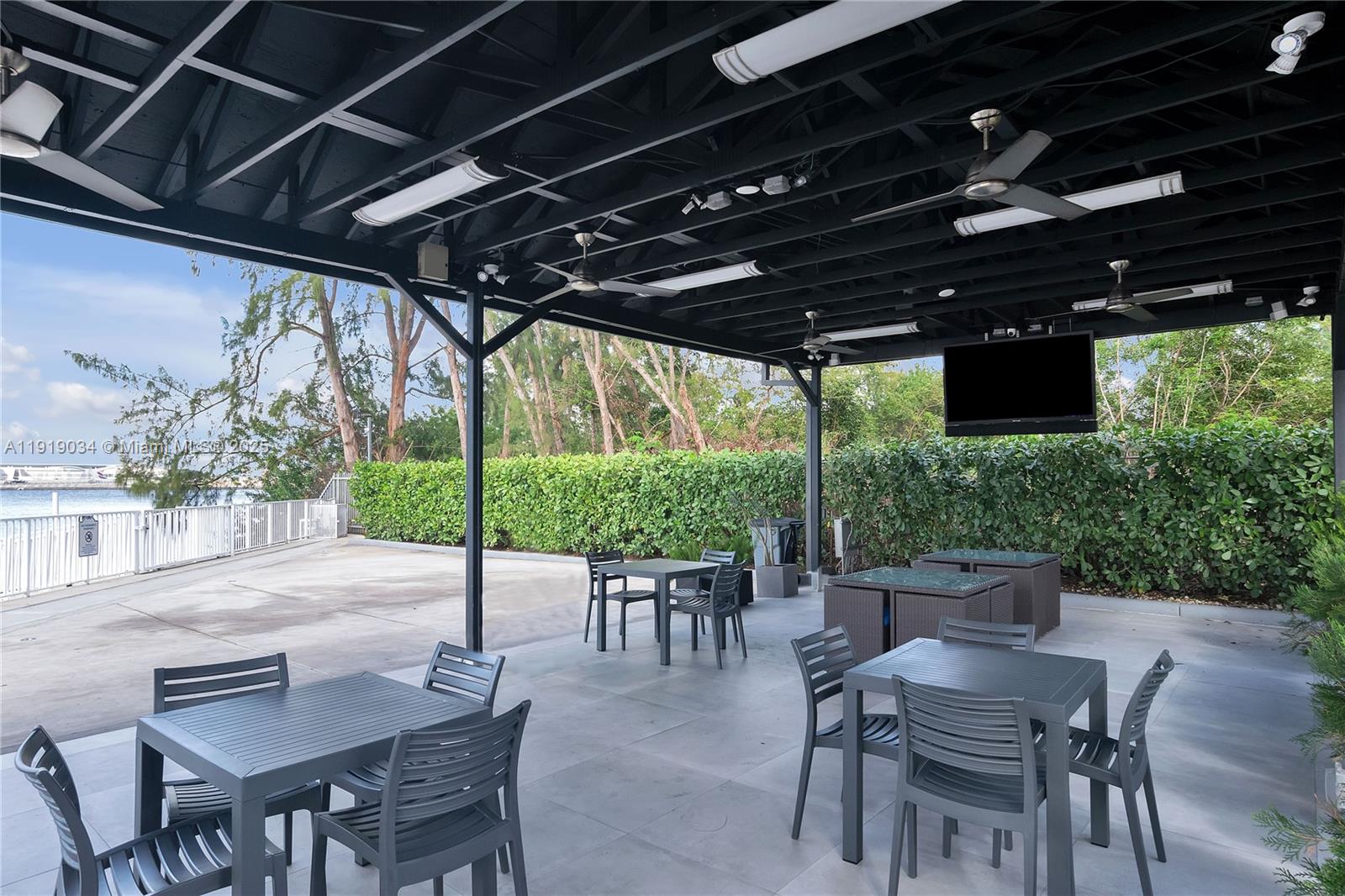 5077 Northwest 7th Street, Unit 610 Miami, FL 33126 - Photo 11 of 20 a patio with an outdoor seating