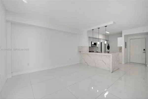 a view of a kitchen with white cabinets