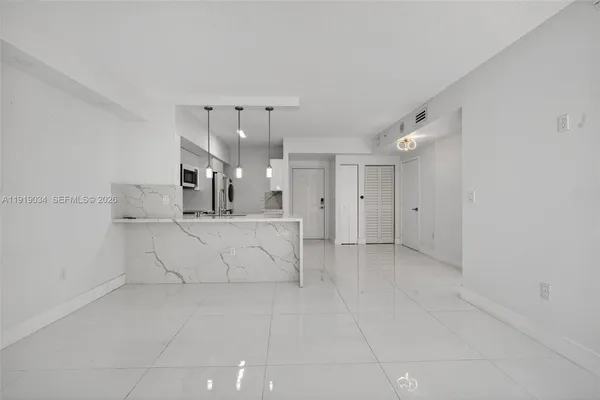 a view of kitchen with center island and stainless steel appliances