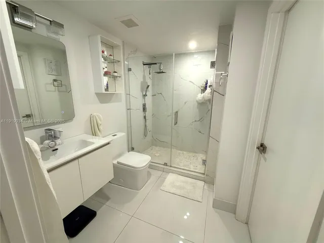 a bathroom with a toilet sink and shower