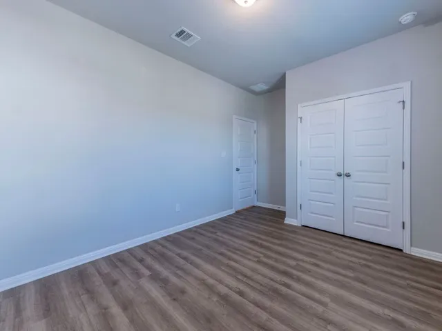 a bathroom with a granite countertop sink a toilet and a mirror
