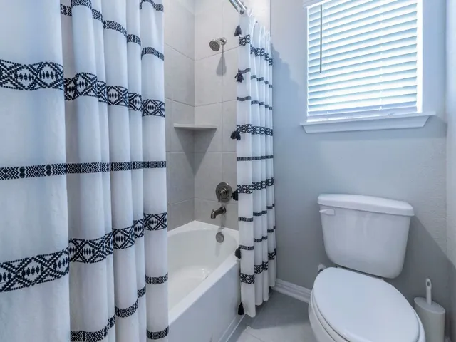 a spacious bedroom with a bed and a window