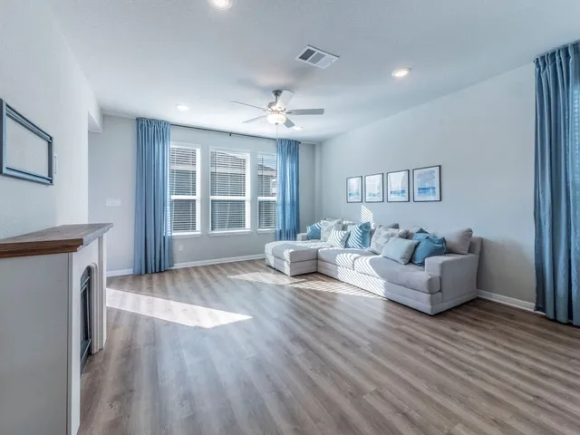 a living room with furniture and windows