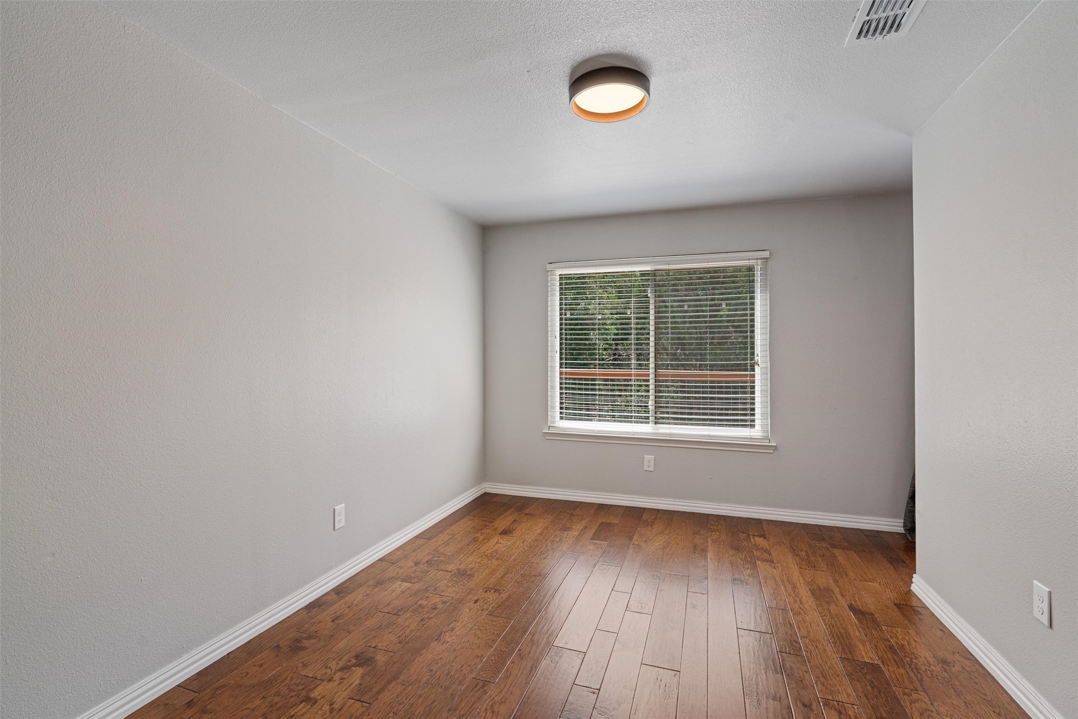 3011 Wadsworth Way Austin, TX 78748 - Photo 10 of 35 Rich hardwood floors complement the neutral walls and natural light in this flexible room.