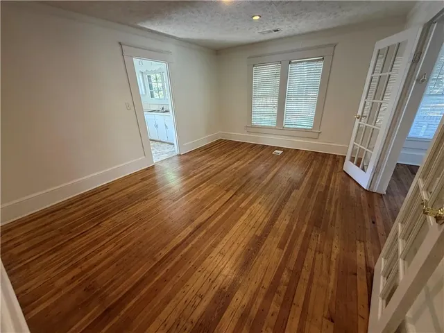a kitchen with granite countertop a stove a sink and a microwave