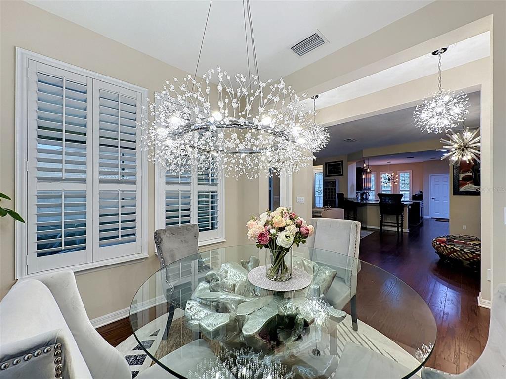 255 Silver Maple Road Groveland, FL 34736 - Photo 19 of 68 a view of a dining room with furniture wooden floor and chandelier