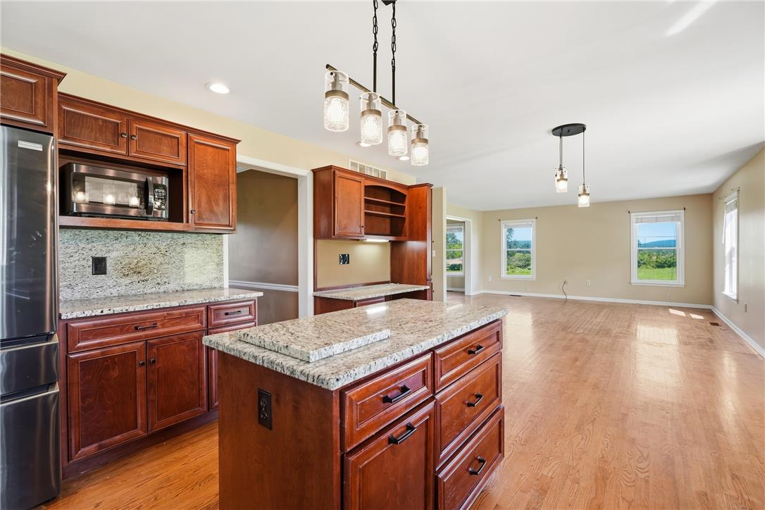 590 Fehr Road Nazareth, PA 18064 - Photo 20 of 79 Rich wood cabinetry and polished granite counters flow seamlessly into the adjoining living space.