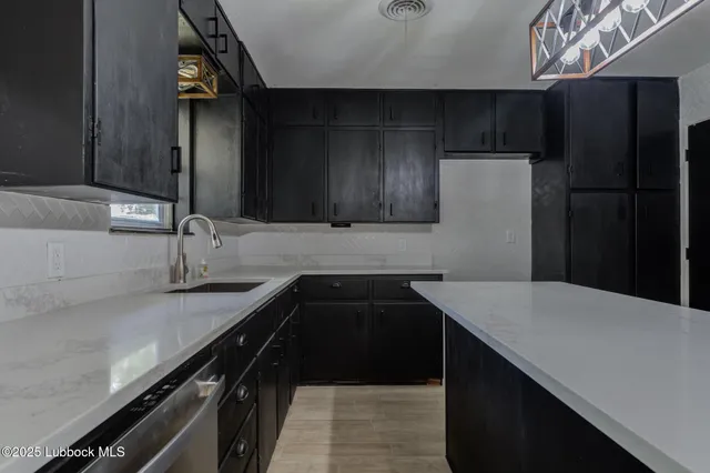 a kitchen with a sink and a refrigerator