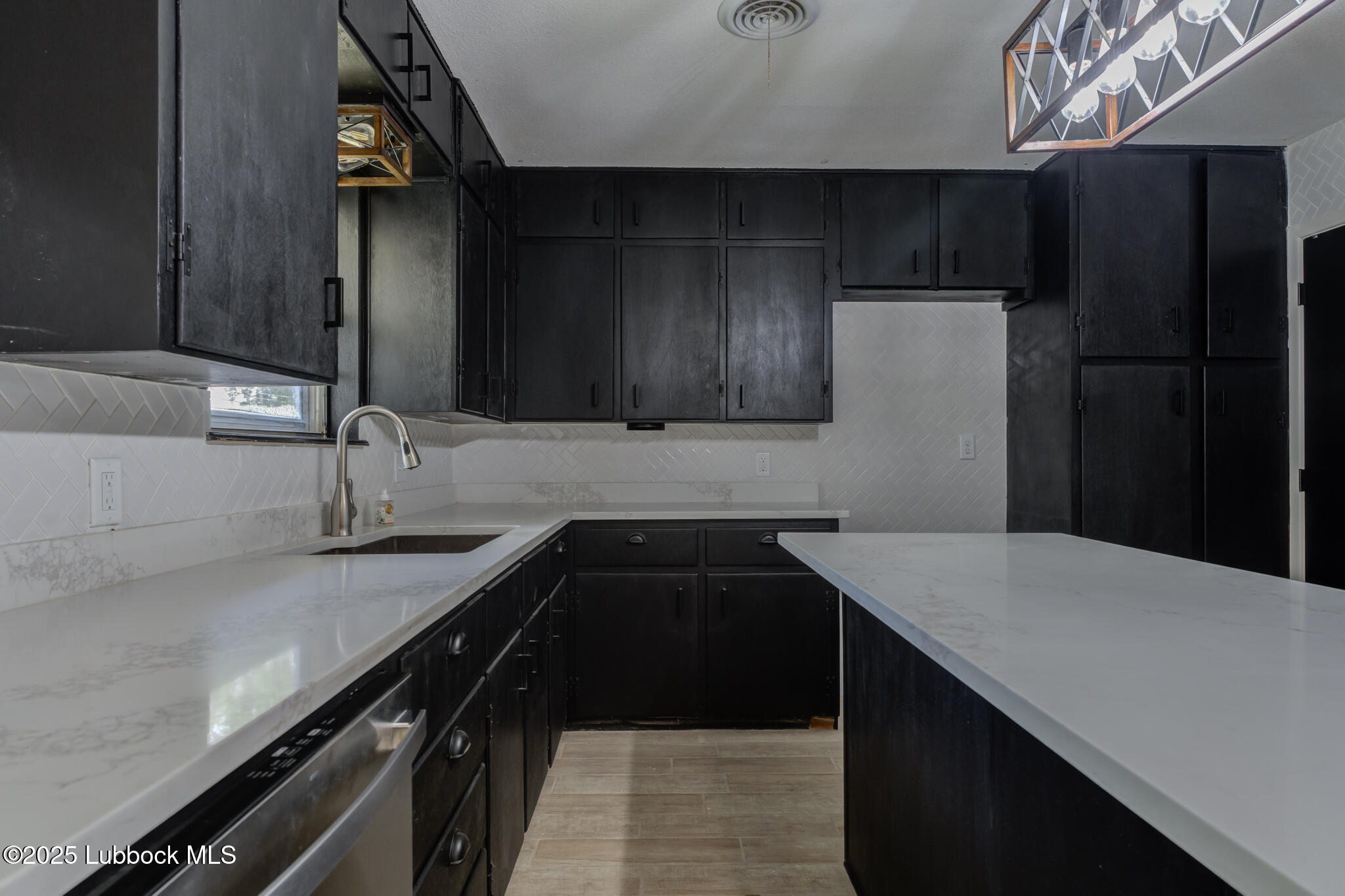 2803 West 18th Plainview, TX 79072 - Photo 13 of 32 a kitchen with a sink and a refrigerator