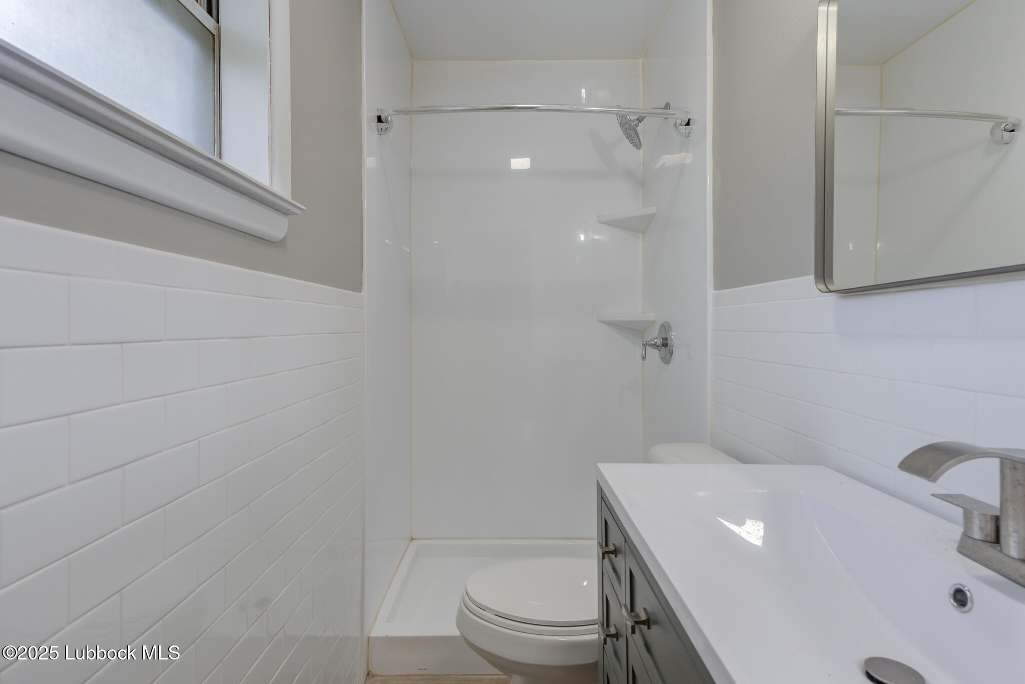 2803 West 18th Plainview, TX 79072 - Photo 22 of 32 a bathroom with a sink a toilet and shower