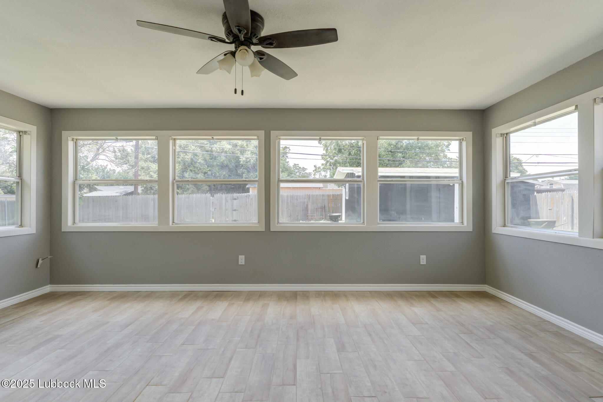 2803 West 18th Plainview, TX 79072 - Photo 27 of 32 an empty room with wooden floor and windows