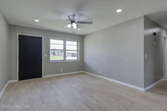 a view of an empty room with a window