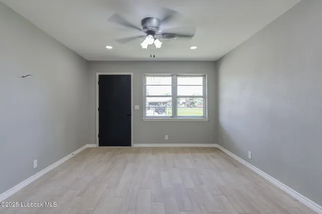 a view of an empty room with a window