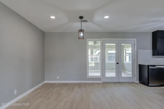 a view of an empty room with a fireplace and a window