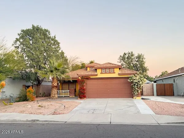 a view of a house with a yard and garage