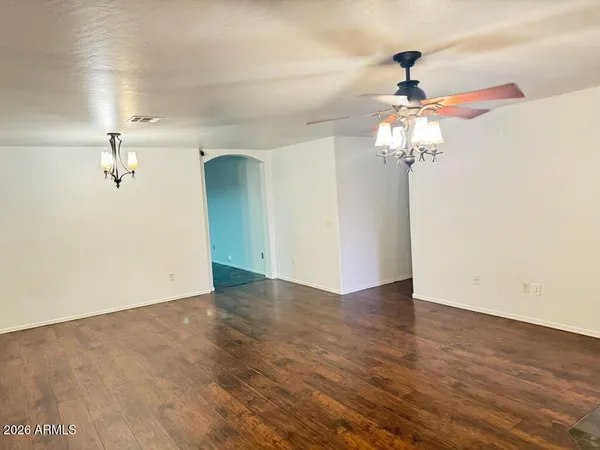 a view of a chandelier fan and wooden floor