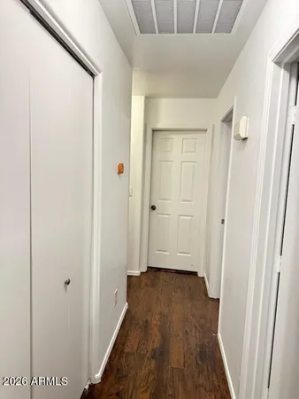 a view of a hallway with wooden floor