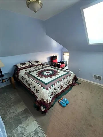 a bedroom with a bed and a table