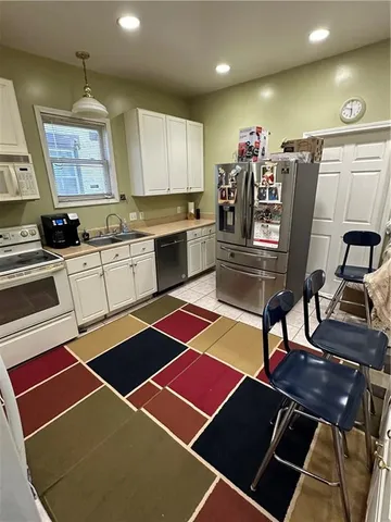 a kitchen with stainless steel appliances kitchen island granite countertop a sink and a stove
