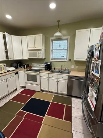 a kitchen with a stove sink and cabinets