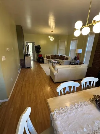 a living room with furniture and a large mirror