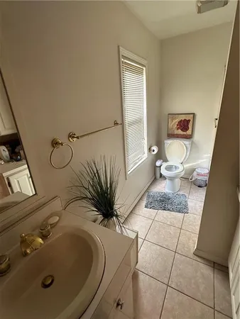 a bathroom with a granite countertop sink a mirror and a shower