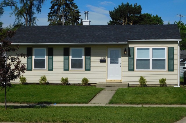 308 South Buffalo Grove Road Buffalo Grove, IL 60089 - Photo 1 of 13 a front view of a house with a yard