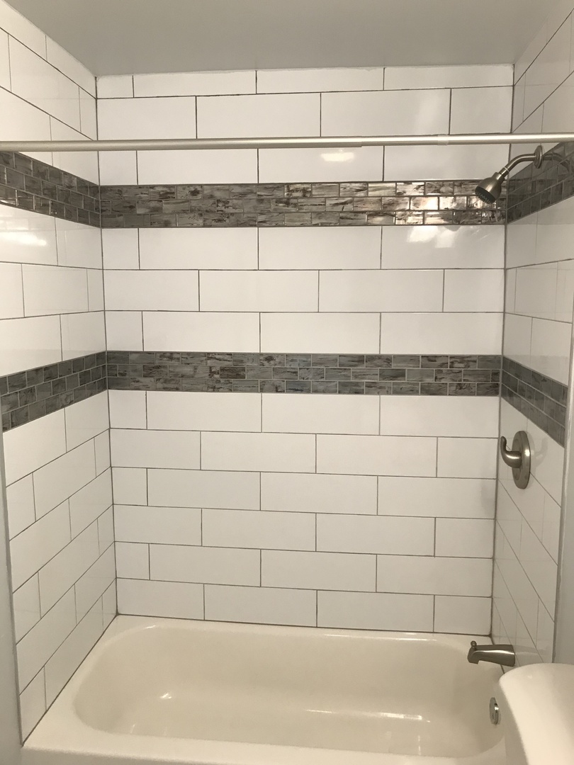 308 South Buffalo Grove Road Buffalo Grove, IL 60089 - Photo 6 of 13 a bathroom with a bathtub